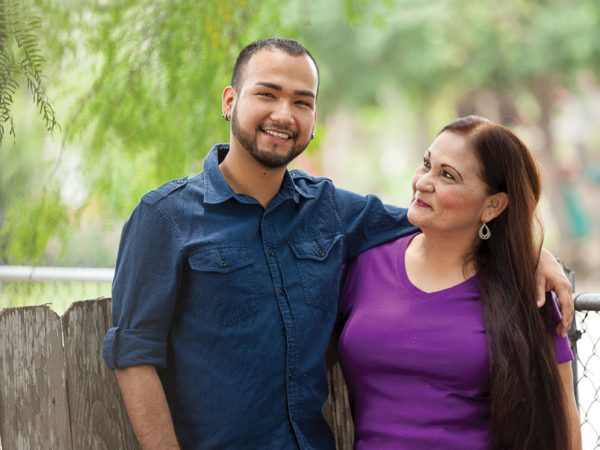 A man putting his arm around a woman smiling